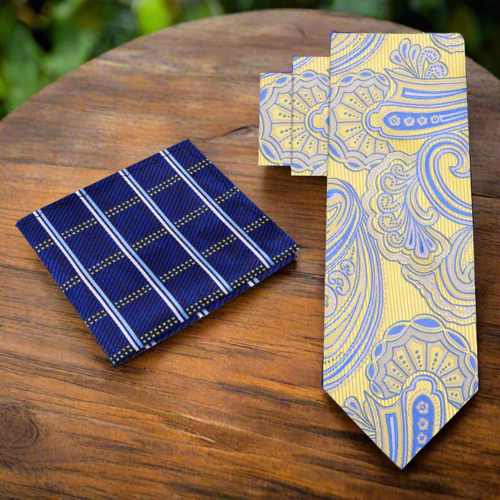 Close-up of a yellow and blue paisley tie with a subtle swirl pattern