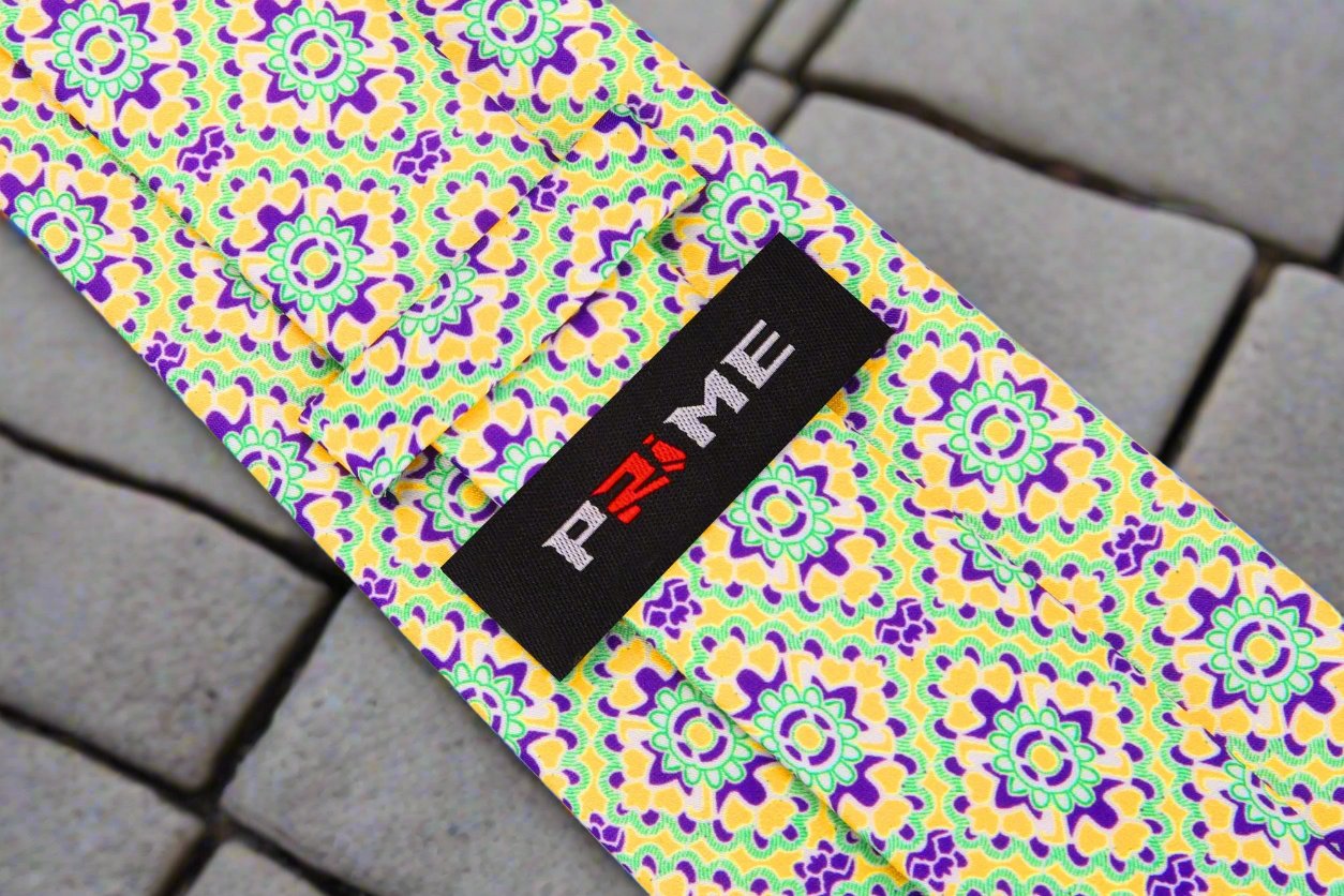 Close-up of the vibrant yellow silk necktie showcasing its intricate mosaic design.