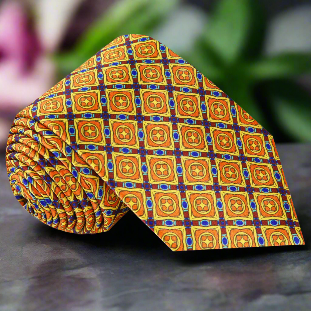 Front view of a stylish men's silk tie with yellow and orange geometric pattern