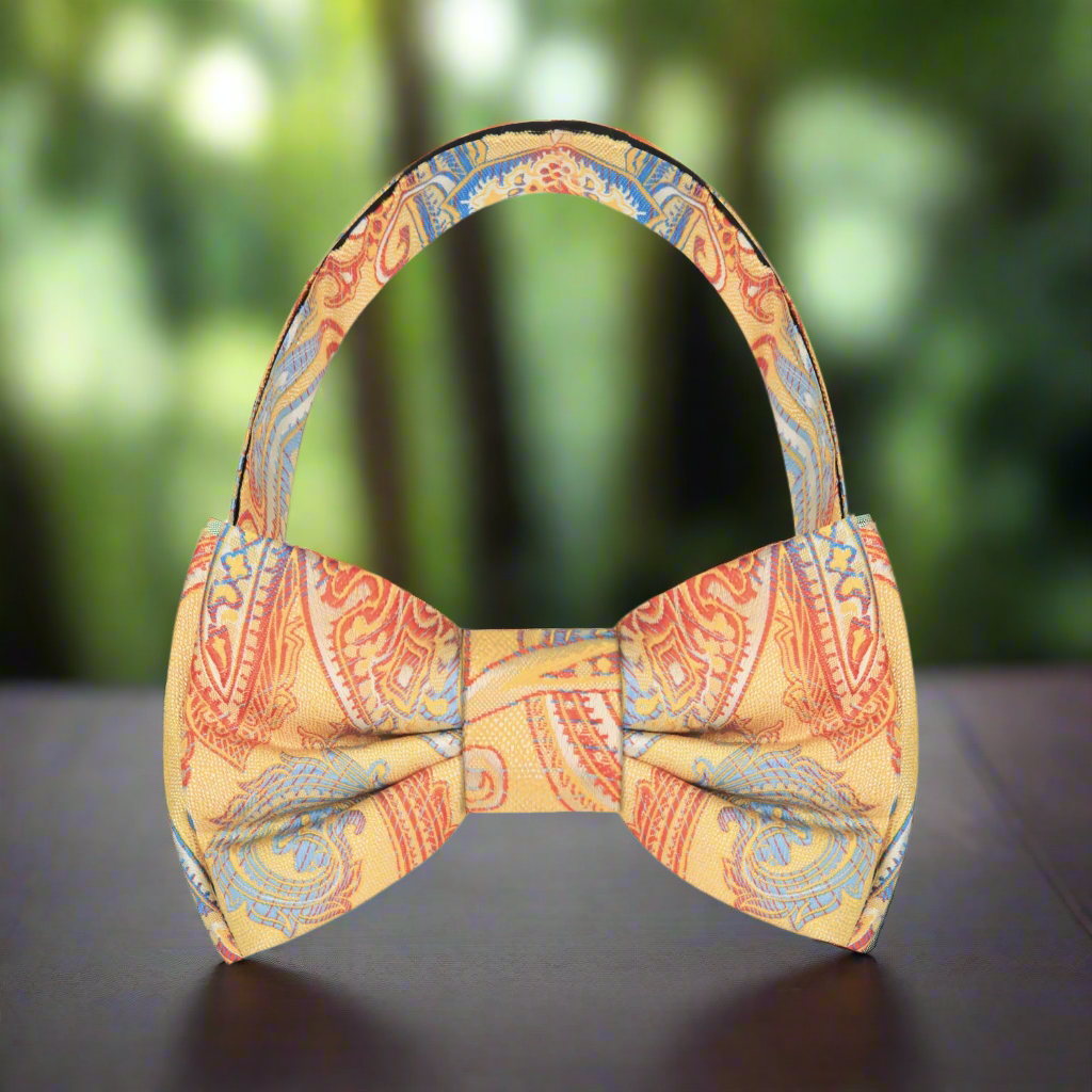 Close-up of vibrant paisley pattern on a silk bow tie suitable for summer weddings