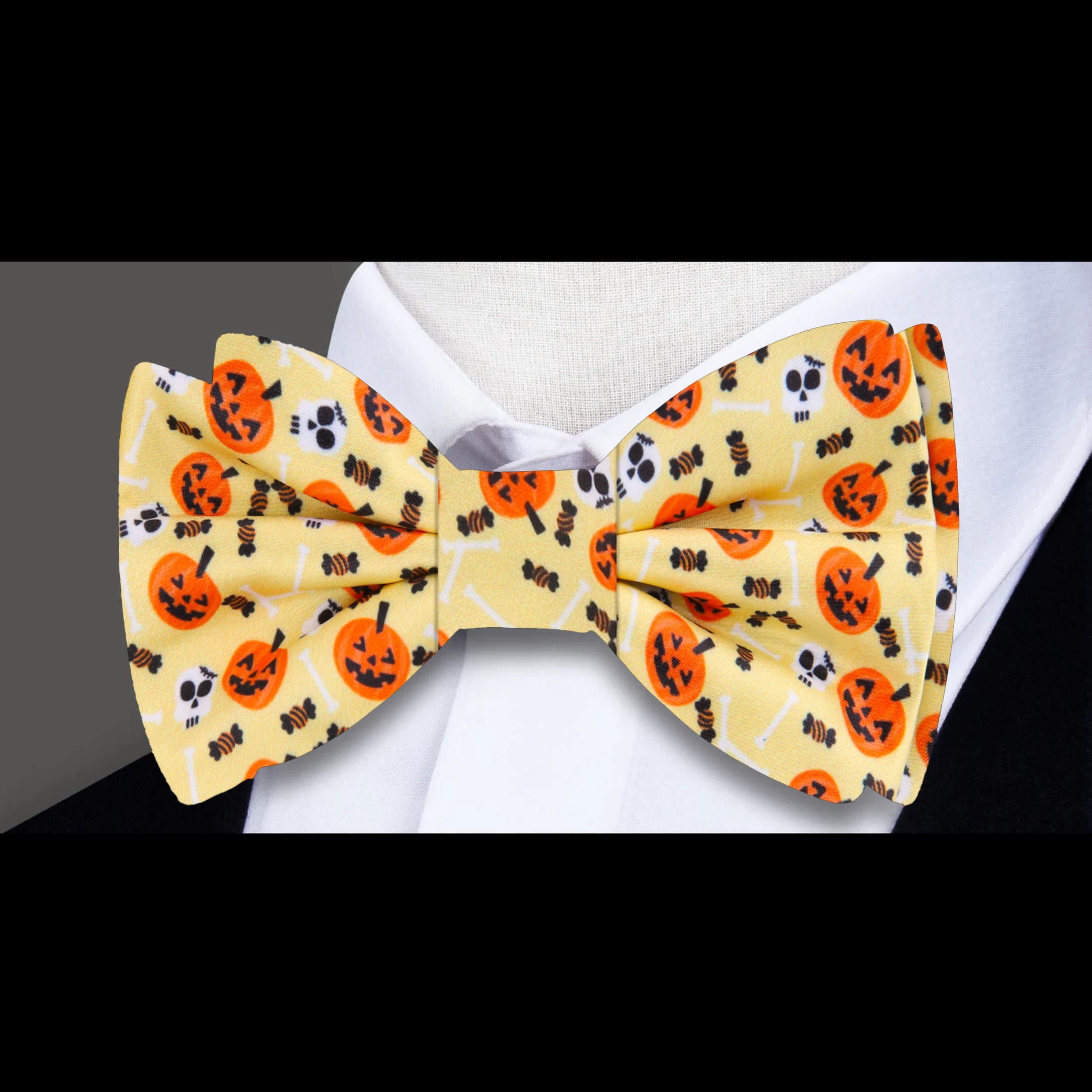 Close-up of mens Halloween pumpkin bow tie with orange and black design