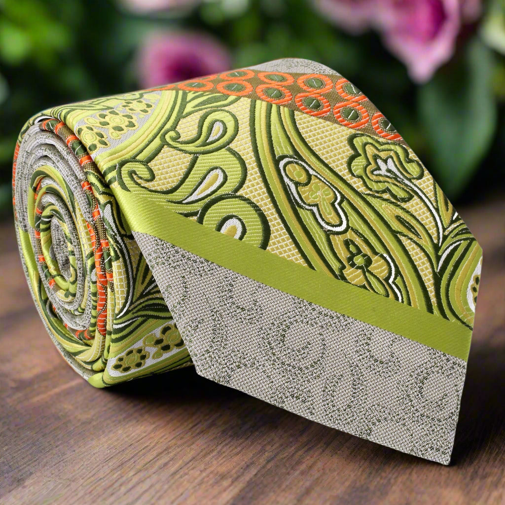 Close-up view of a vibrant yellow and orange paisley silk tie, showcasing intricate patterns and textures.