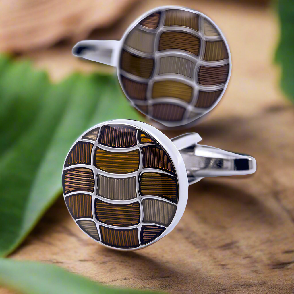 Stylish cufflinks showcased against a dark navy shirt, highlighting their colorful details.