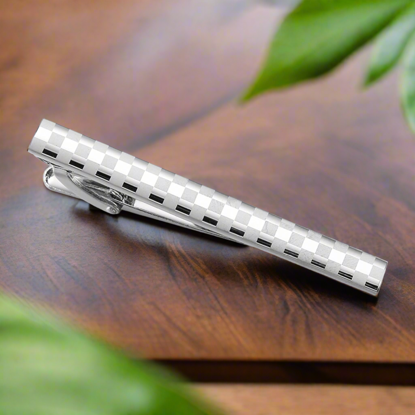 Elegant tie bar in mahogany with chrome floral design, perfect for formal occasions.
