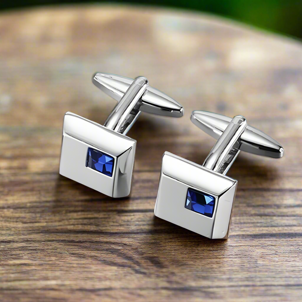 Elegant cuff links and tie bar set displayed on a neutral background