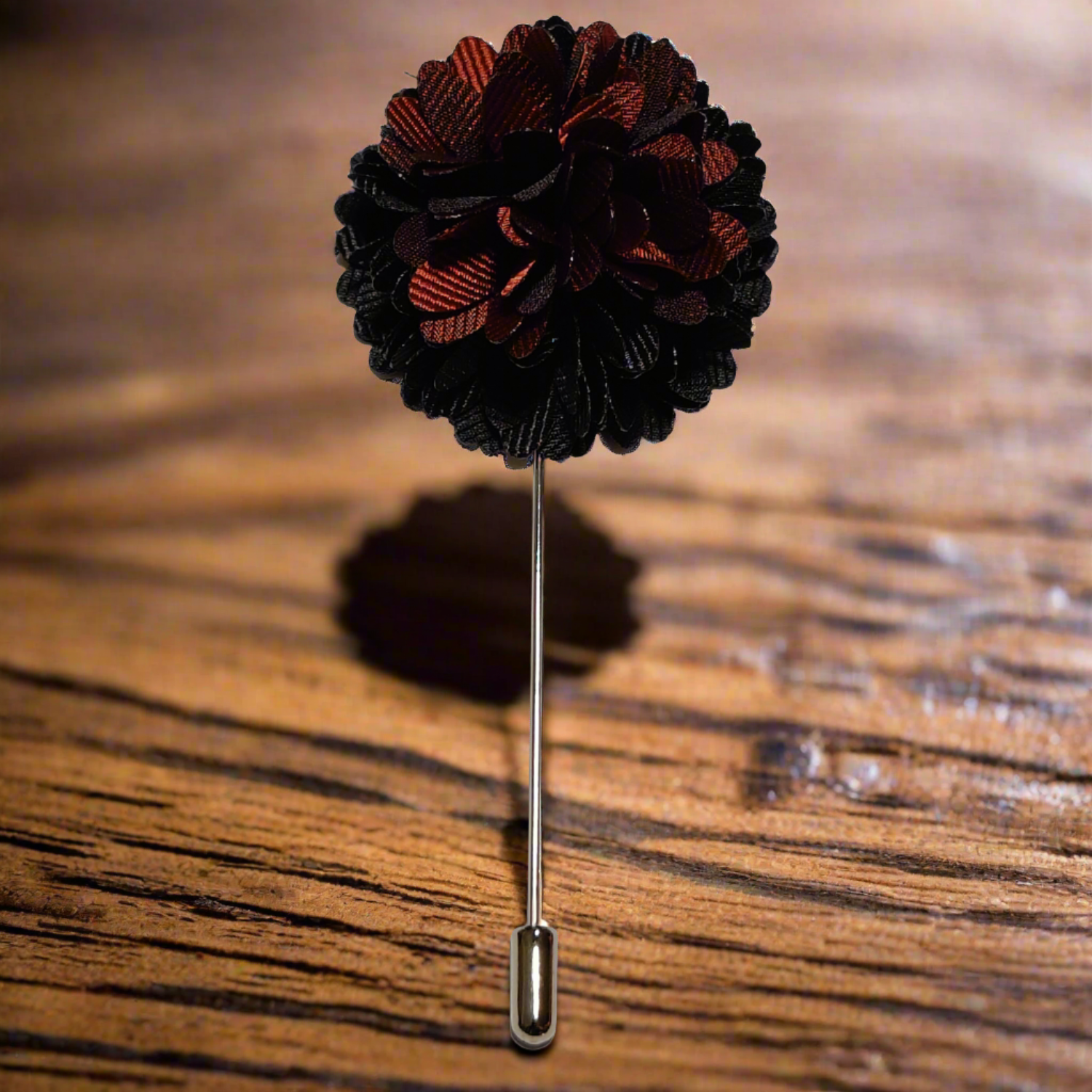 Close-up of elegant lapel pin showing detailed polyester petals and black-brown gradient tones