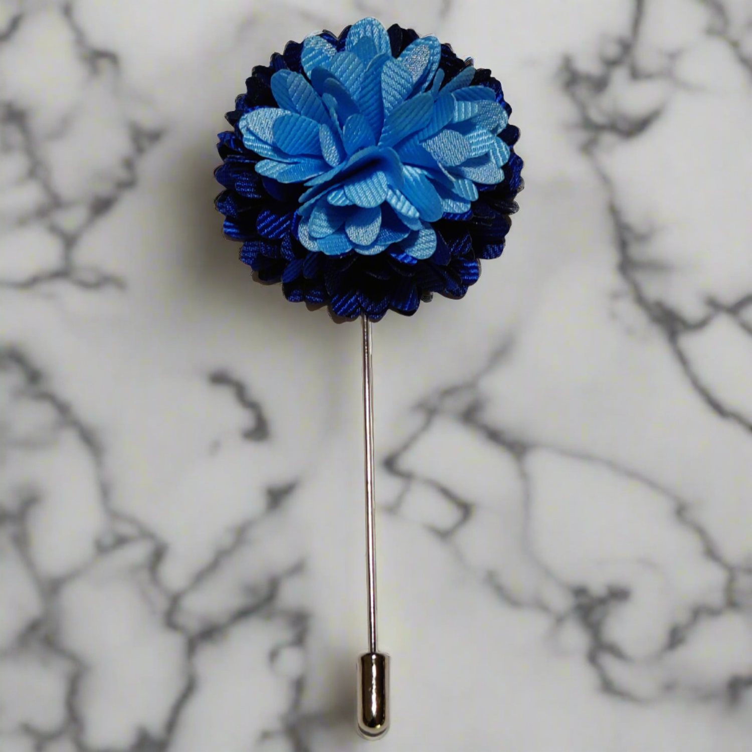 Front view of a blue blossom lapel pin on a suit lapel, highlighting its elegant flower shape