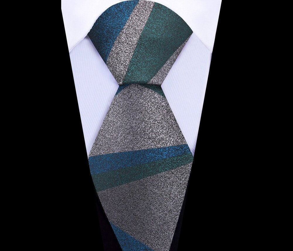 Model wearing a luxury silk necktie with abstract design at a formal event, highlighting its versatility.