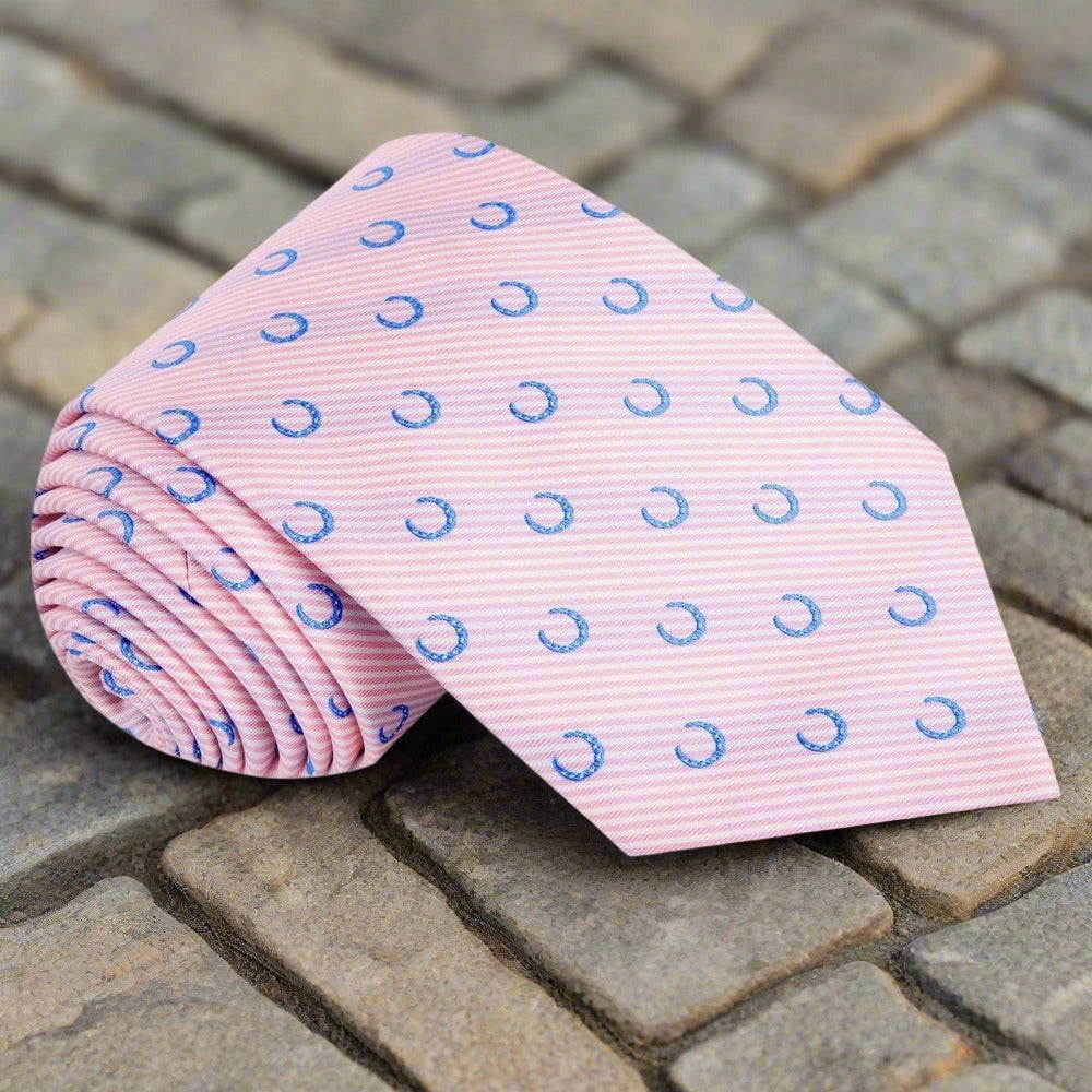 Close-up of whimsical horseshoe pattern silk tie in pink and blue, perfect for weddings