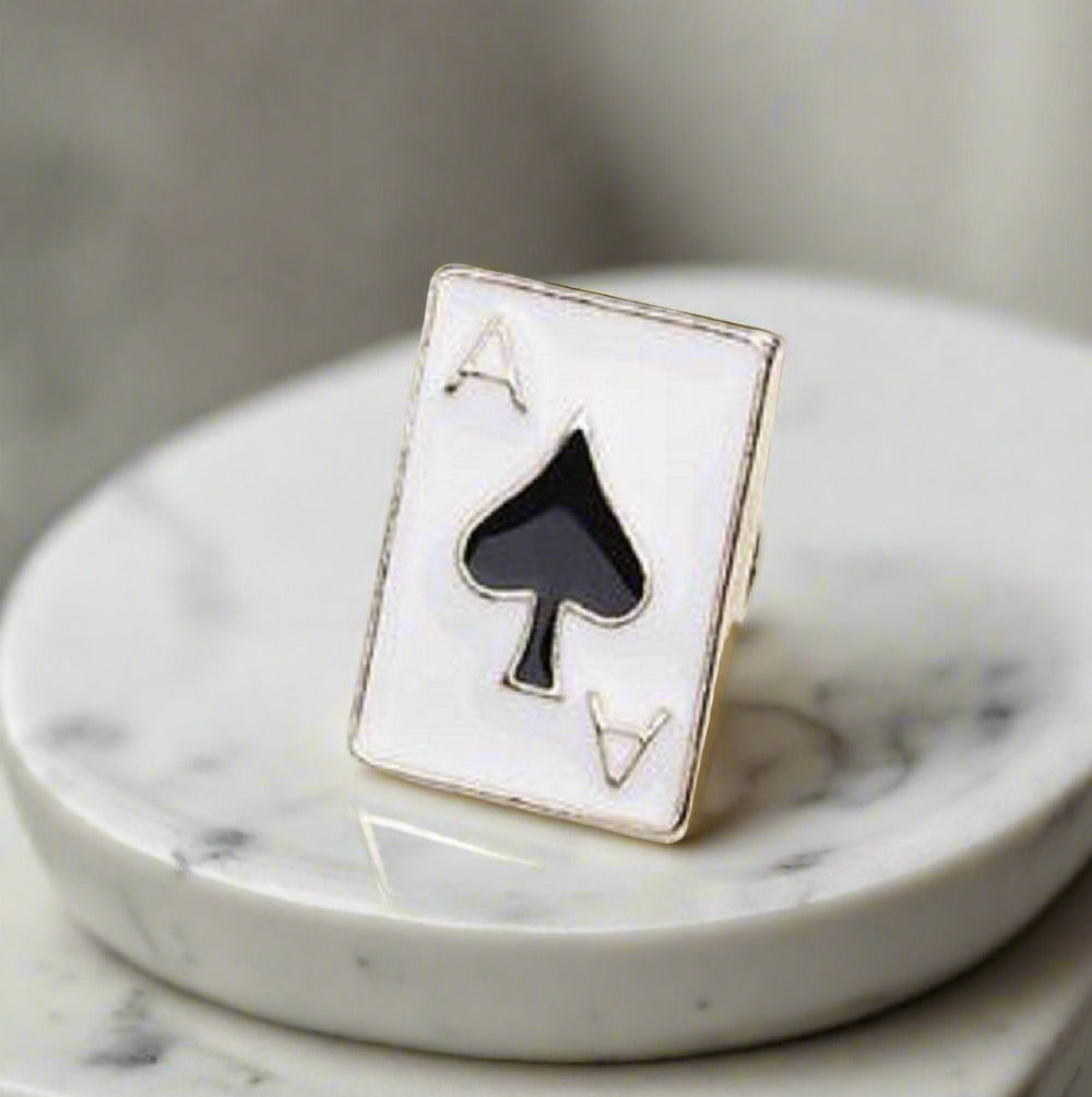 Close-up of an elegant casino night lapel pin showing the ace of spades design