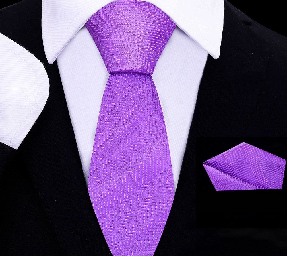 Front-facing view of the kids necktie and amethyst silk pocket square folded neatly on a wooden table