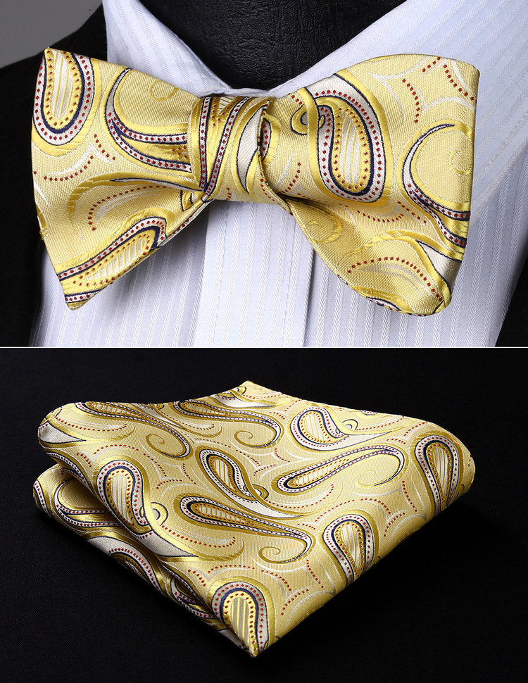 Close-up of vibrant paisley silk bow tie in yellow and pink for formal wear