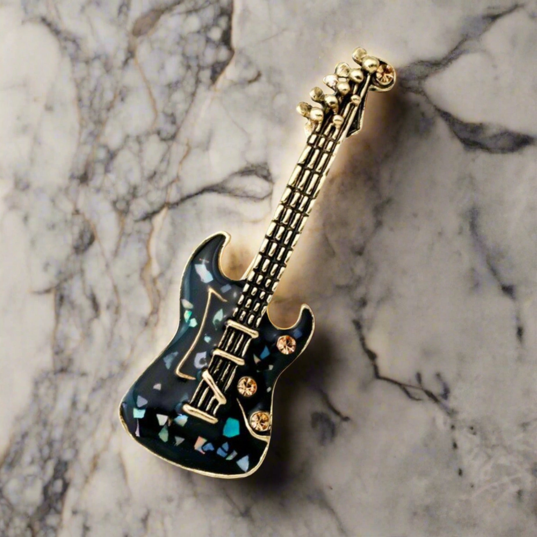 Close-up of the premium guitar lapel pin in blue pearl finish