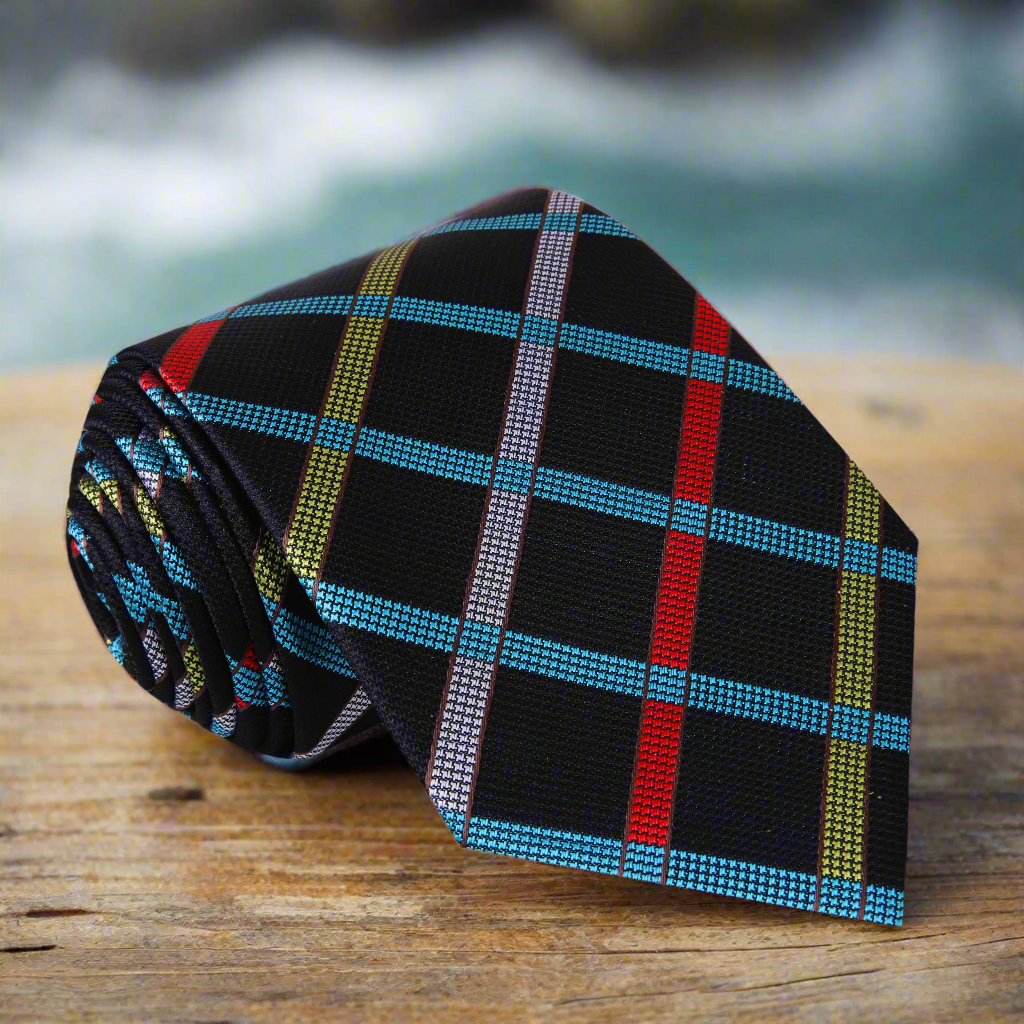 Silk plaid necktie with vibrant red, blue, yellow, and grey pattern on a white shirt