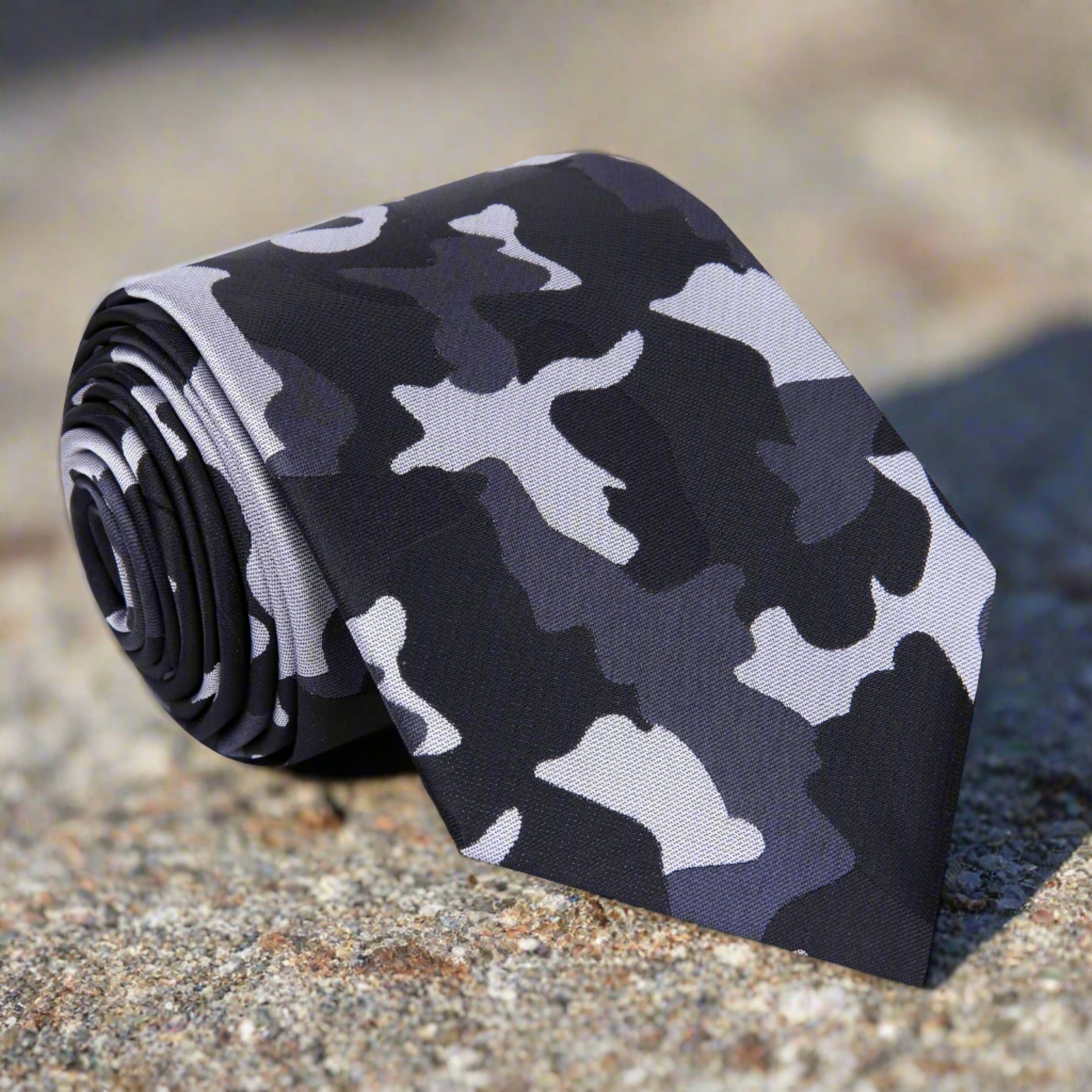 Close-up of the stylish camouflage necktie showcasing its unique fleck pattern, perfect for formal wear.
