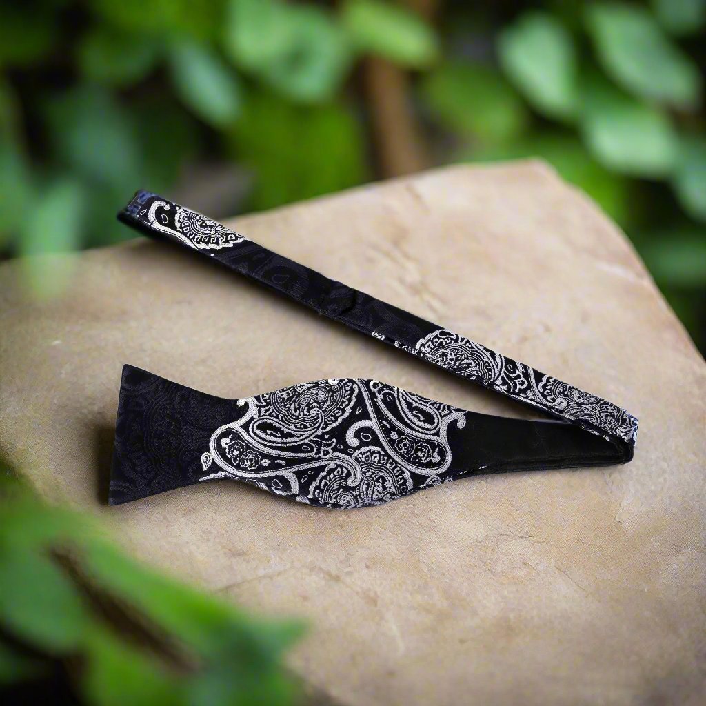 Close-up of paisley bow tie showcasing intricate details and silk texture.