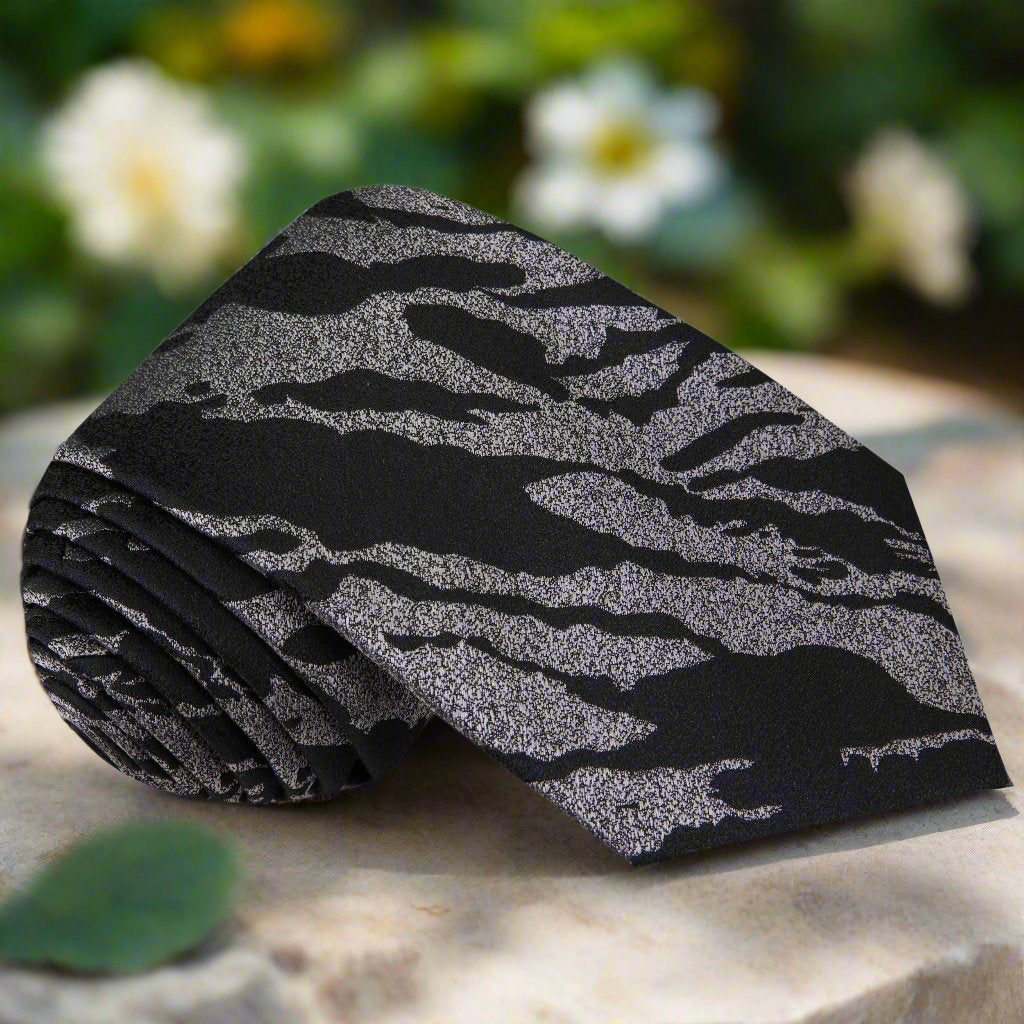 Close-up of onyx pattern silk necktie on a display stand