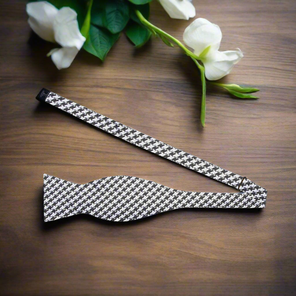 Close-up of houndstooth silk bow tie with self-tie knot detail.