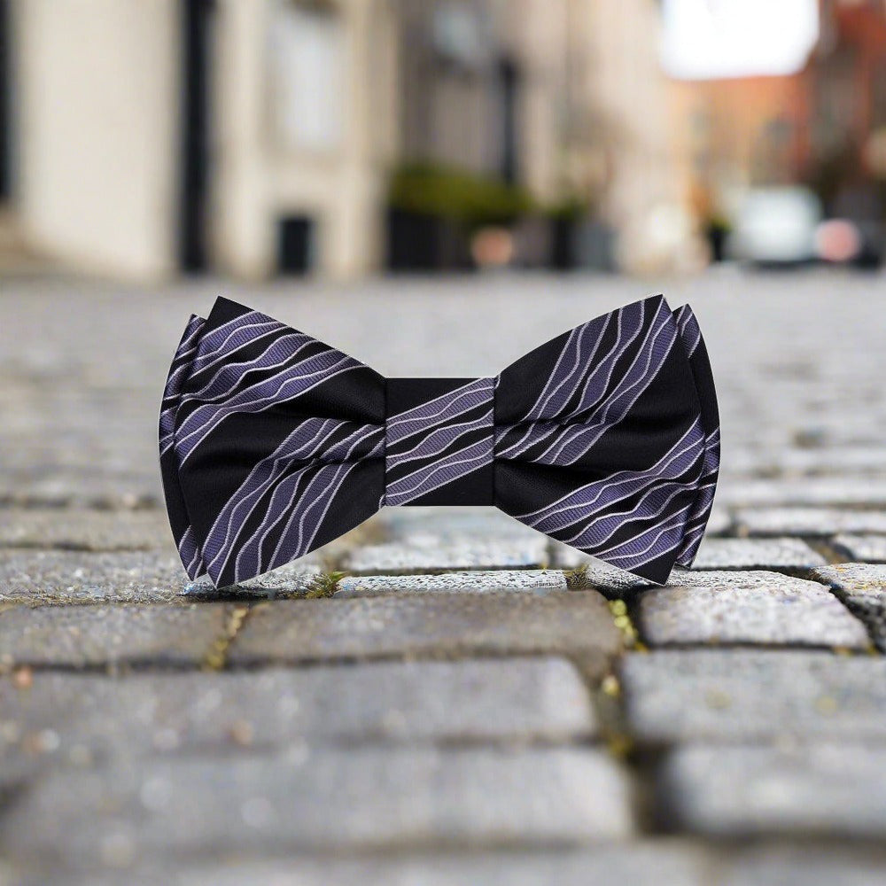Close-up of a blue silk bow tie with wavy design, perfect for weddings