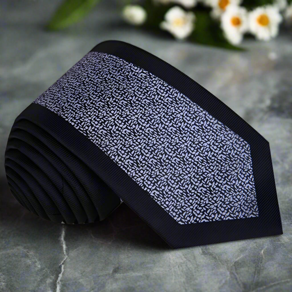Close-up of black silk necktie with grey textured pattern for formal events