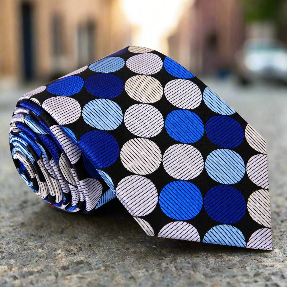 Large polka dot silk necktie in vibrant colors, showcasing the bold pattern against a white shirt.