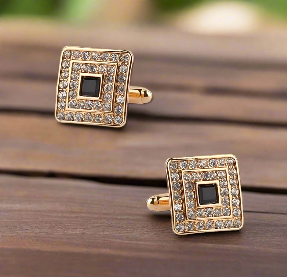 Elegant black square cufflinks with gold accents on a dress shirt