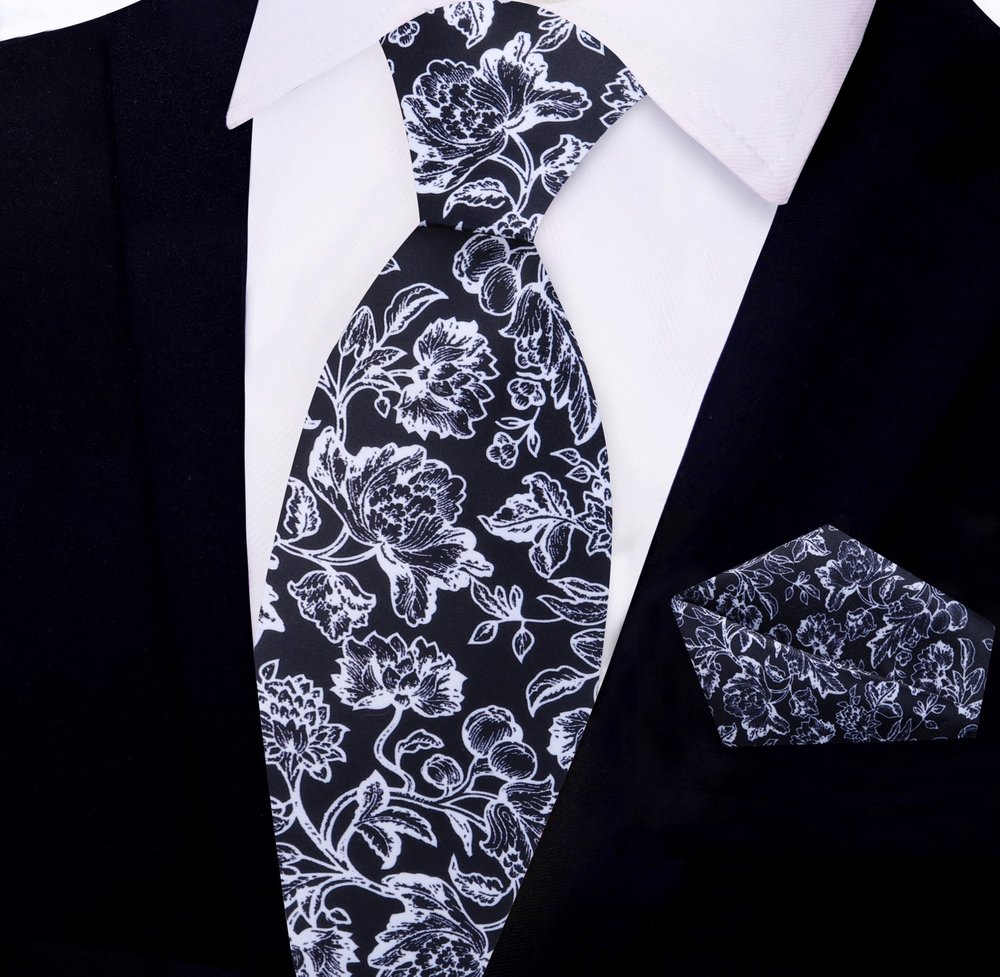 Close-up of black filigree silk tie paired with white dress shirt — ideal necktie for formal office settings