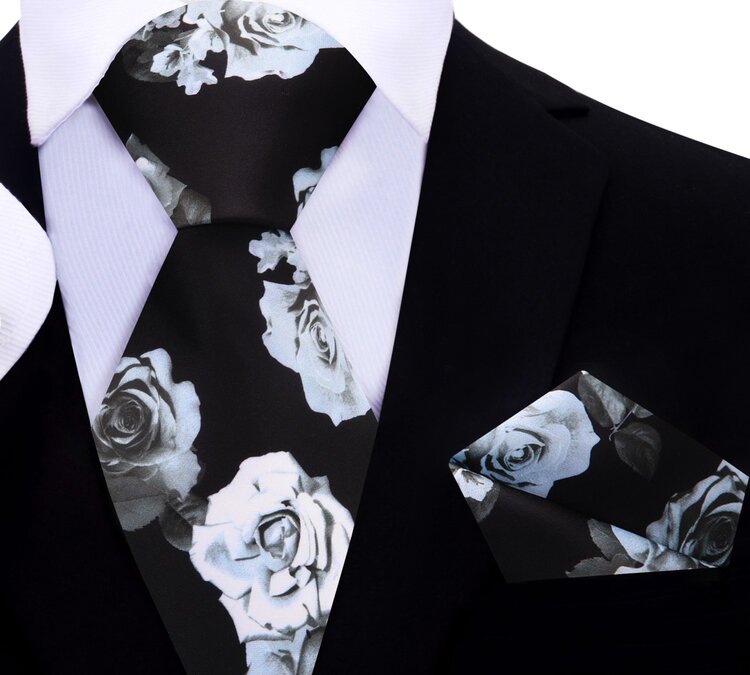 Model wearing the elegant floral silk necktie with a white dress shirt, demonstrating its perfect fit for formal occasions.