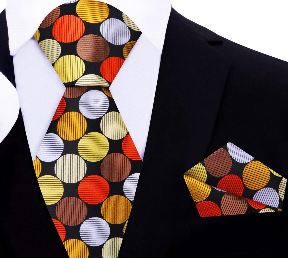 Close-up of the vibrant polka dot silk necktie, emphasizing the texture and quality of the fabric.