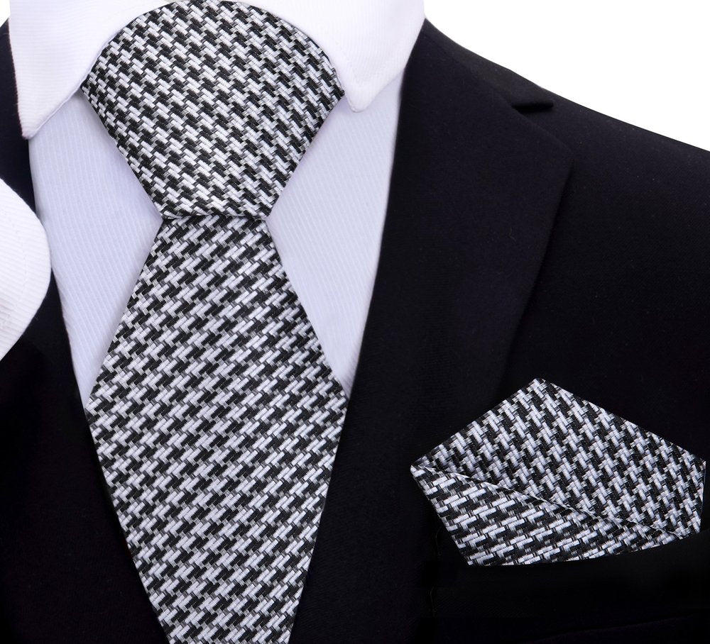 Man wearing the elegant silk necktie with a dark suit for a formal event