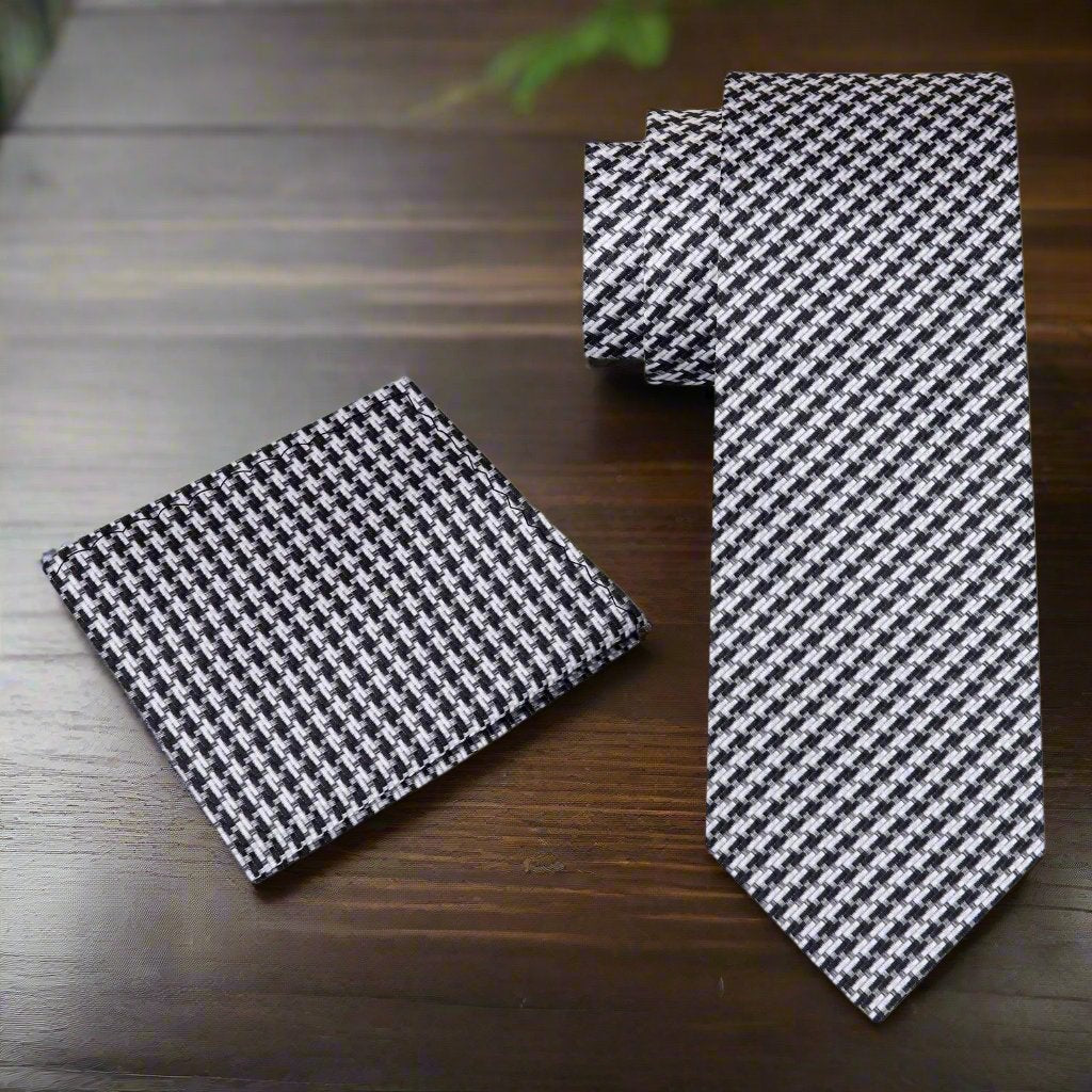Matching pocket square in gold and black houndstooth design complementing the necktie