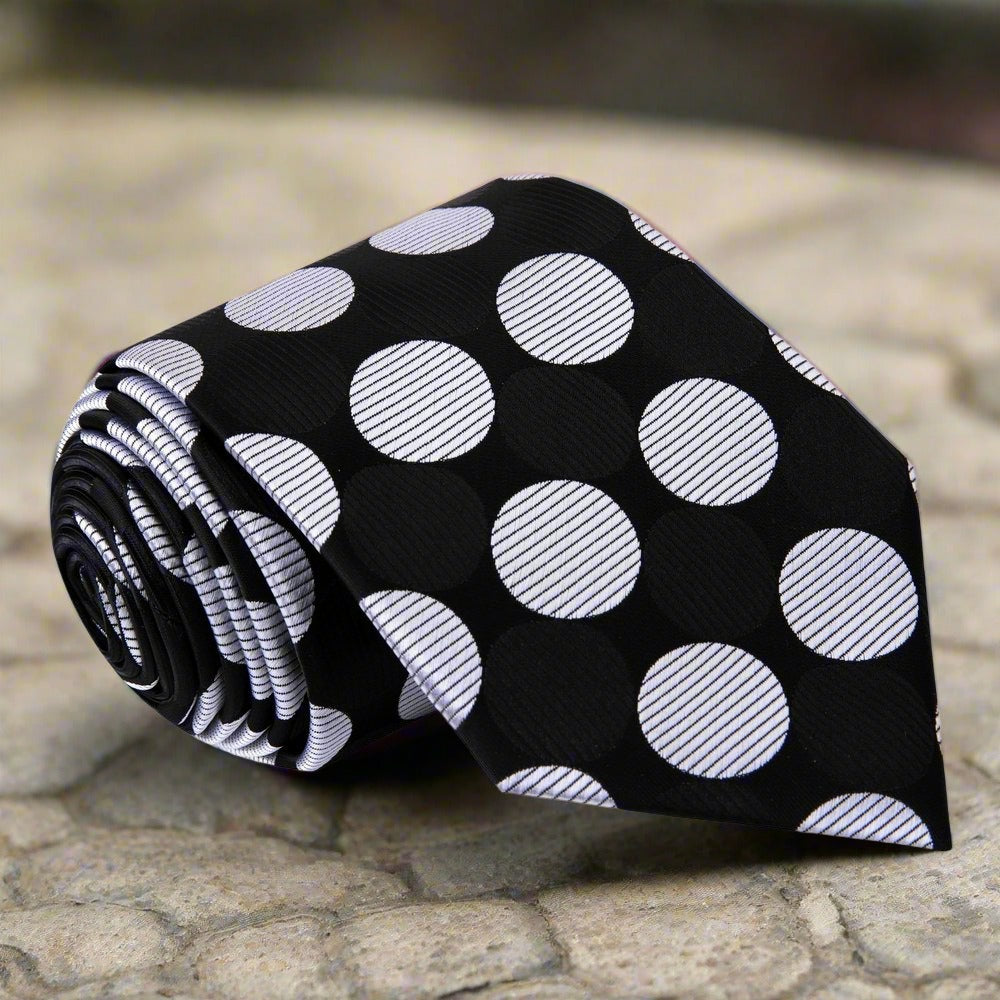 Man wearing a colorful polka dot tie at a wedding, displaying a stylish and confident look.