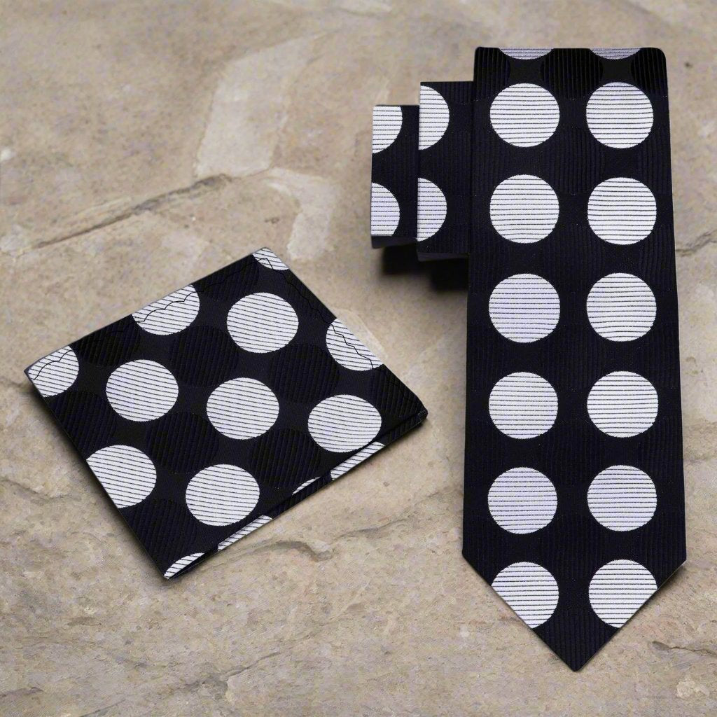 Close-up of the vibrant polka dot silk necktie, emphasizing the texture and quality of the fabric.
