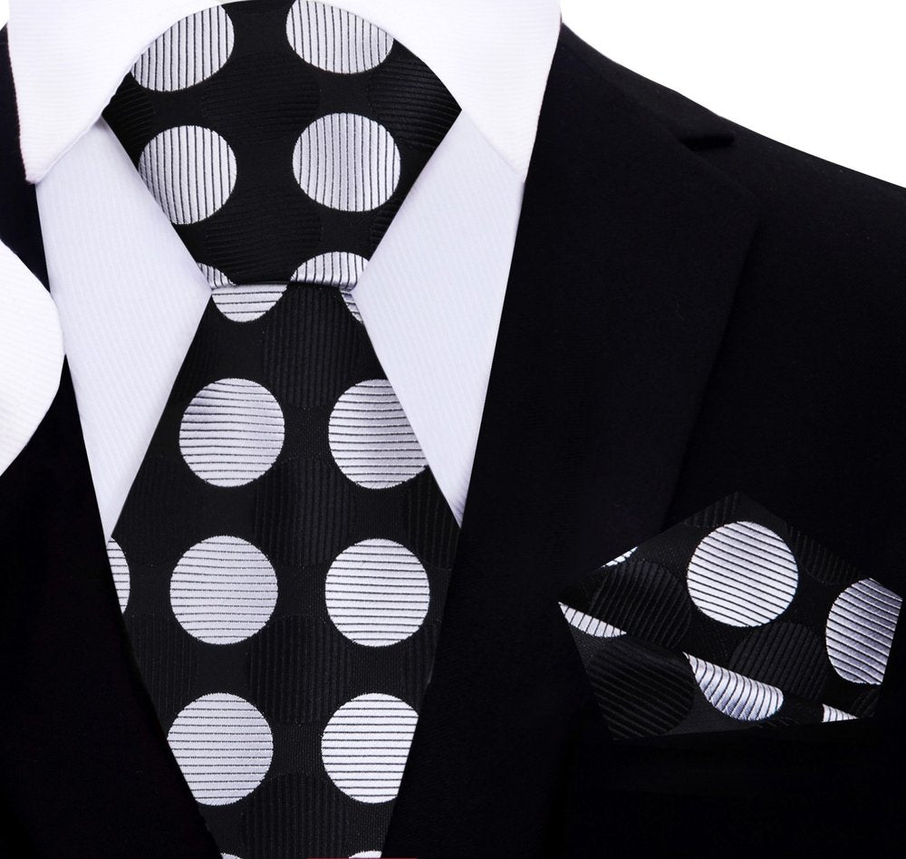 Large polka dot silk necktie in vibrant colors, showcasing the bold pattern against a white shirt.