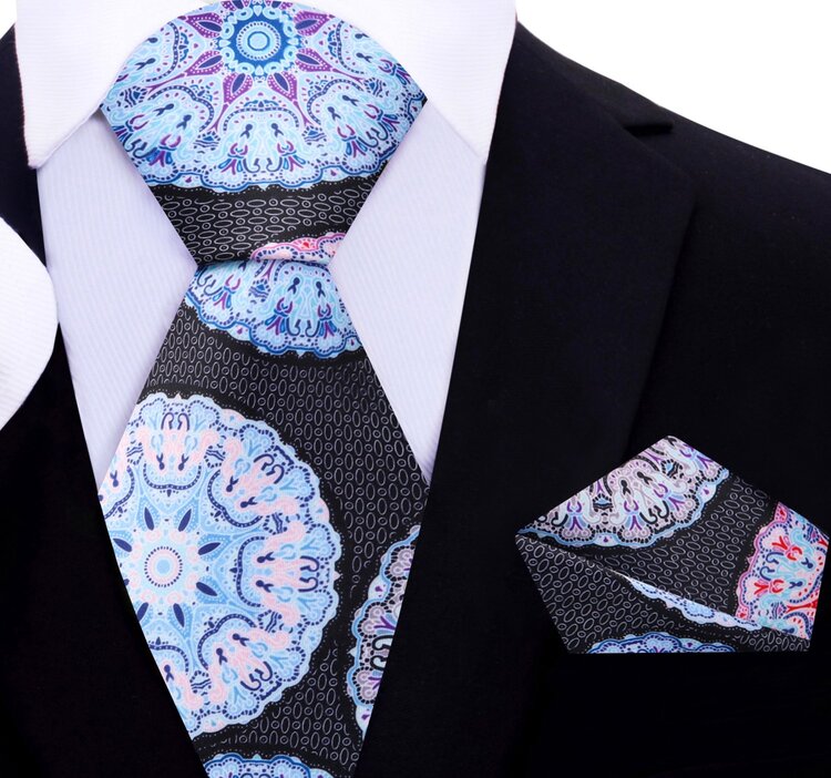 Close-up of the silk necktie showing pink kaleidoscope pattern and smooth texture
