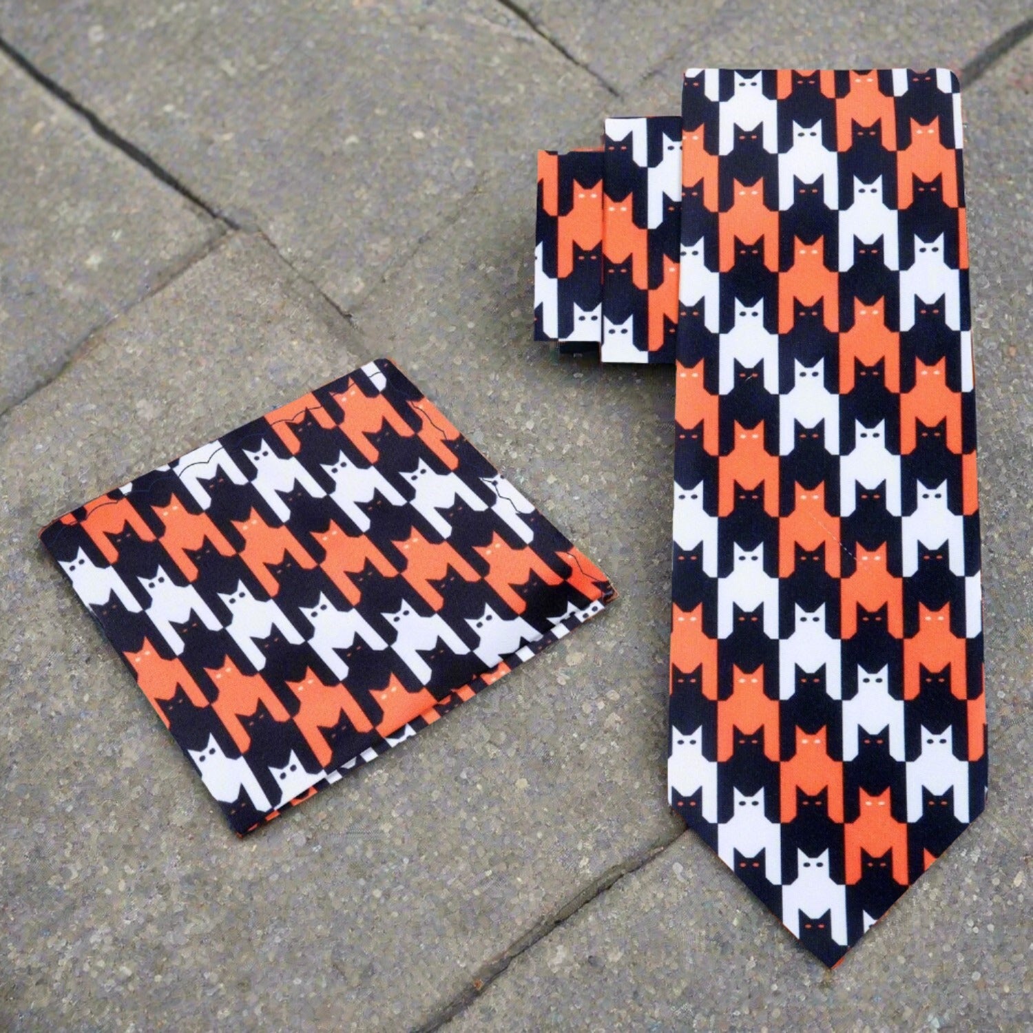 Close-up of the Halloween themed silk tie showcasing the intricate bats and cats pattern.