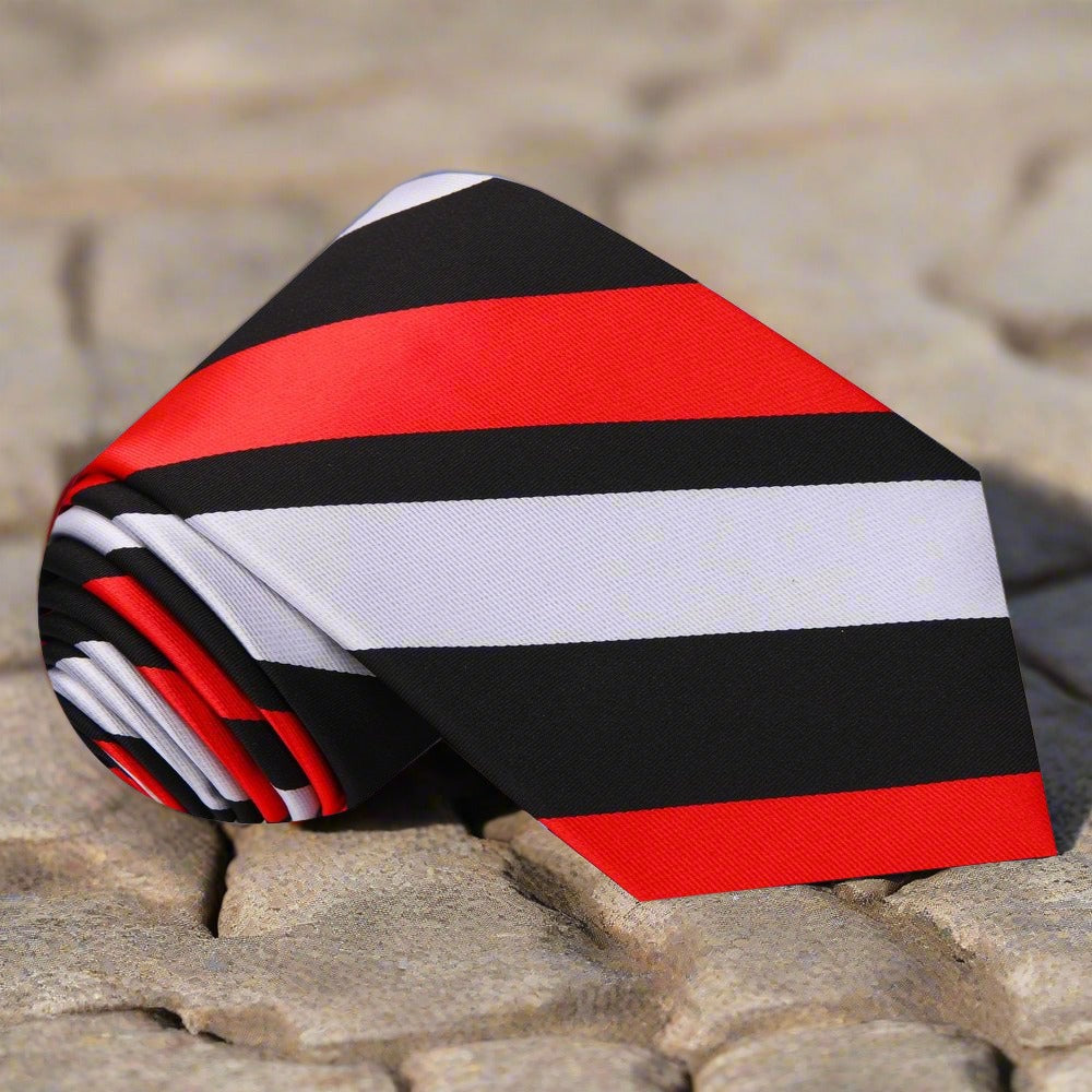 Flat lay of the elegance striped silk tie next to a matching pocket square.