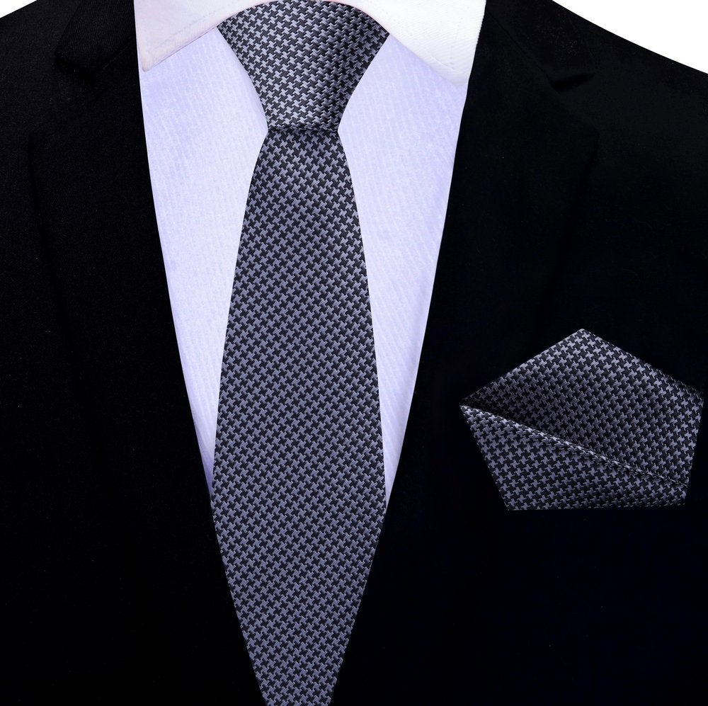 Man wearing the red and blue houndstooth necktie at a business meeting.