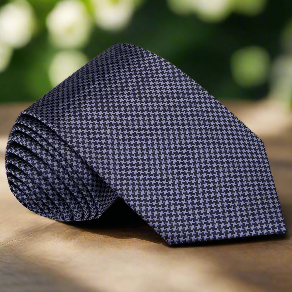 Close-up of the houndstooth pattern on the silk tie, highlighting its quality.
