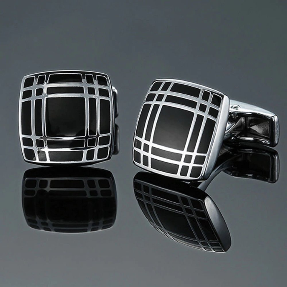 Close-up of intricate silver cufflinks with geometric design for formal occasions