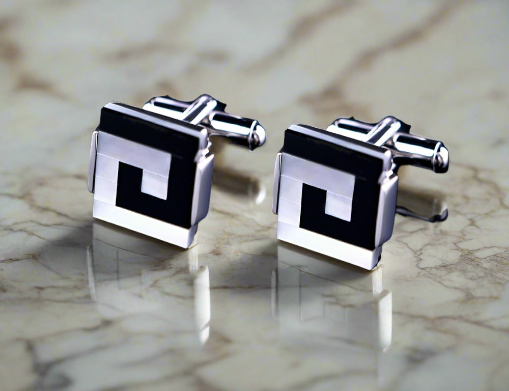 Elegant designer cufflinks featuring red line with black green gemstones, perfect for formal attire.