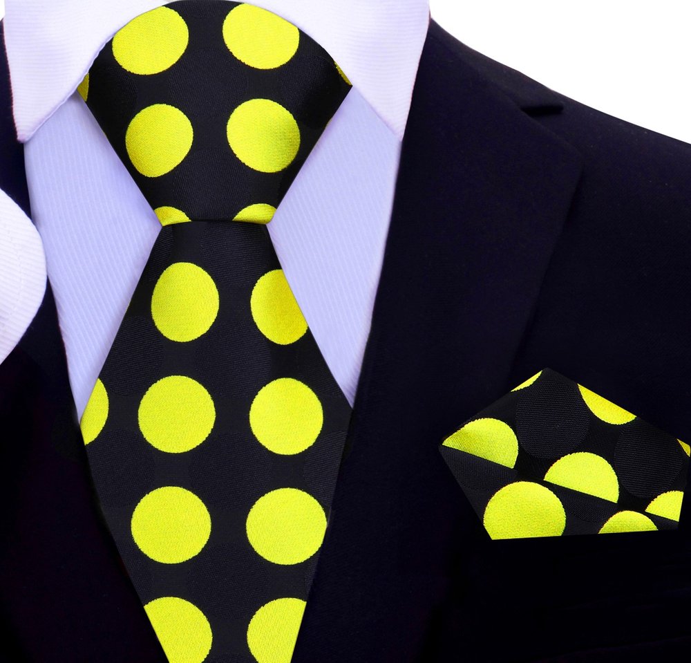 Man wearing a colorful polka dot tie at a wedding, displaying a stylish and confident look.