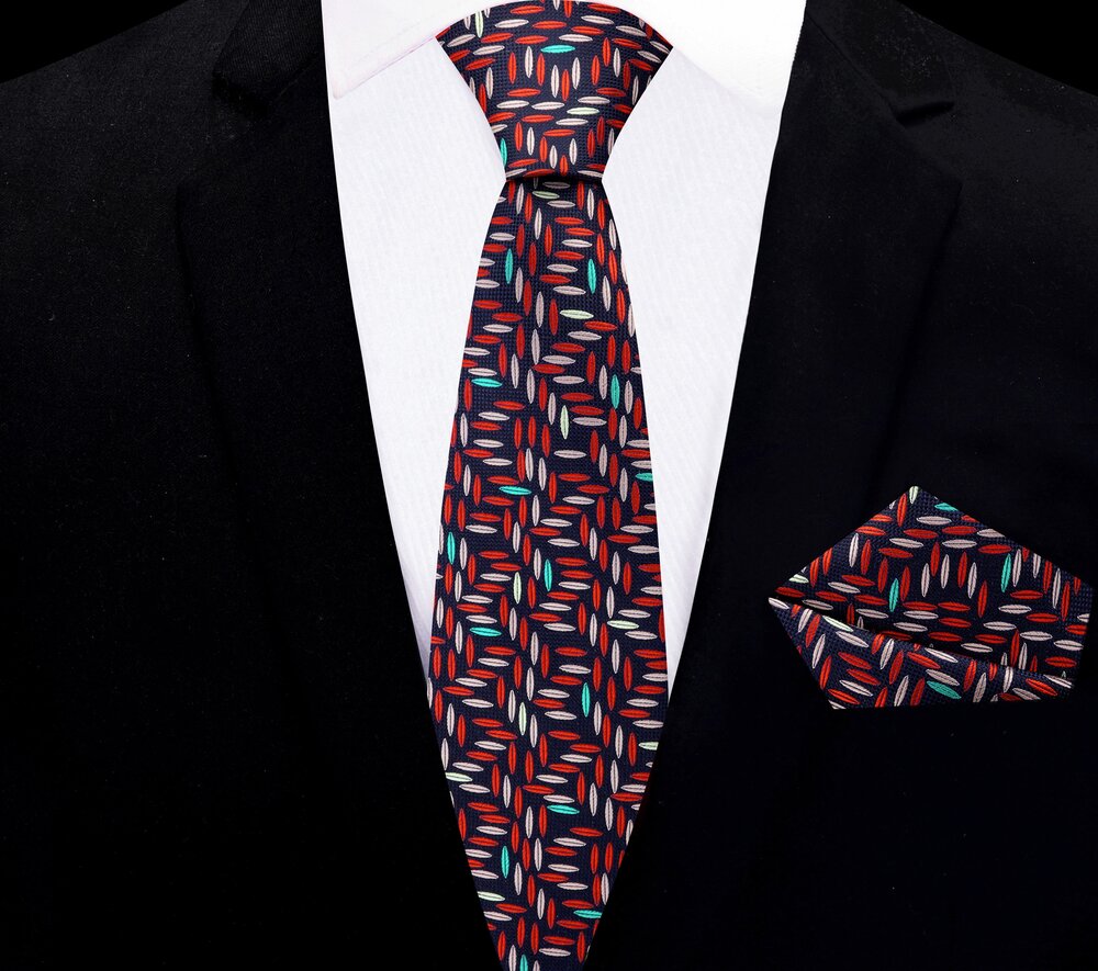 Full view of the Geometric Elegance necktie and pocket square set displayed on a formal suit.