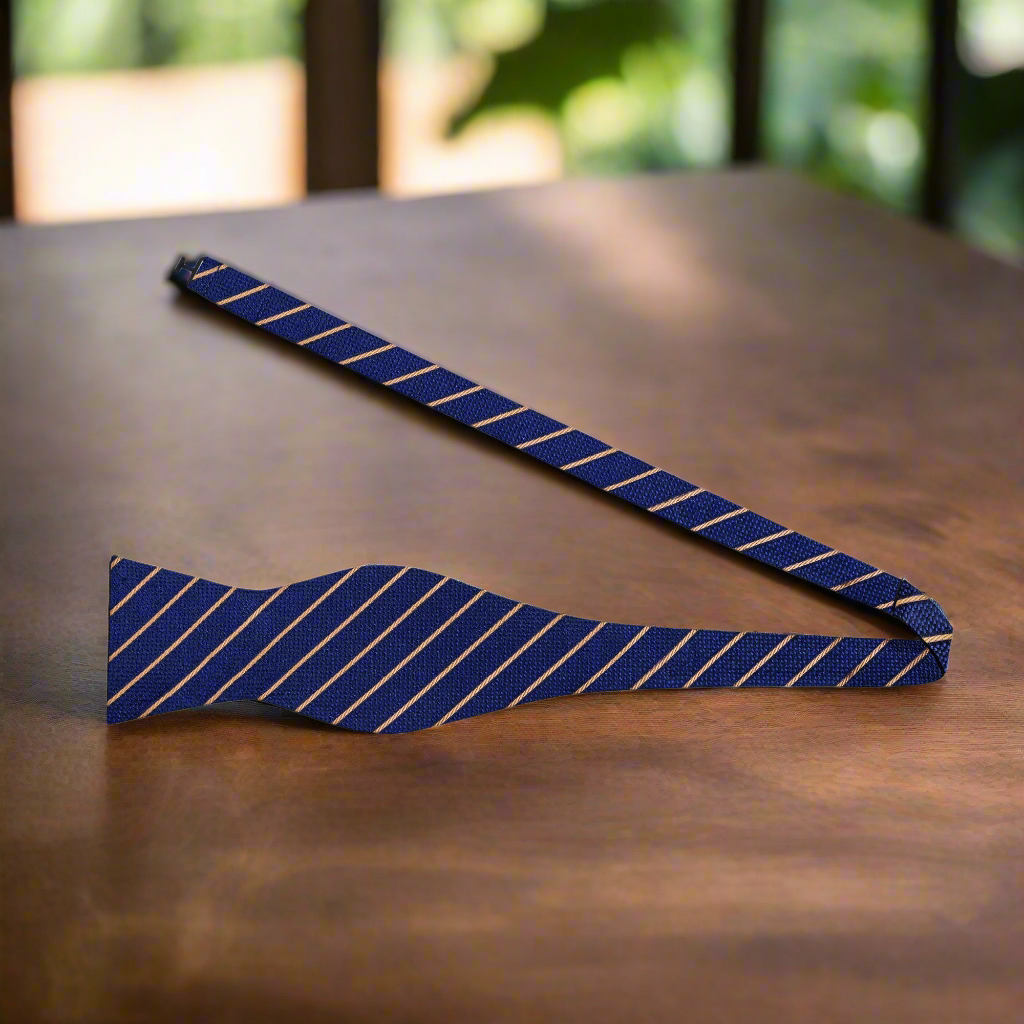 Elegant dark blue stripe bow tie worn with a white dress shirt for formal events