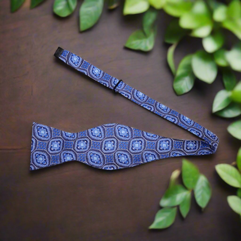 Front view of the blue geometric pattern silk bow tie on a mannequin