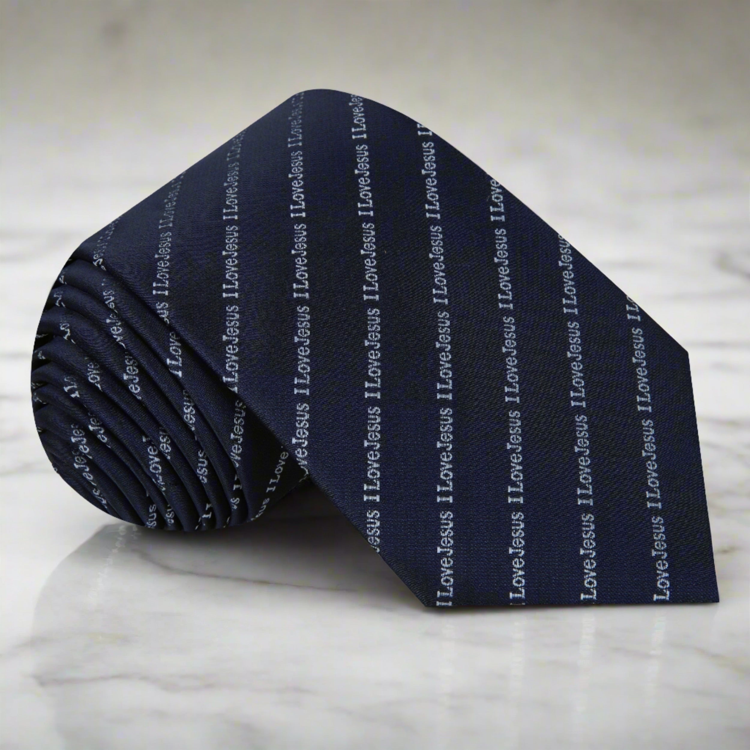 Close-up view of the blue and grey silk necktie with 'I Love Jesus' design, ideal for church services.