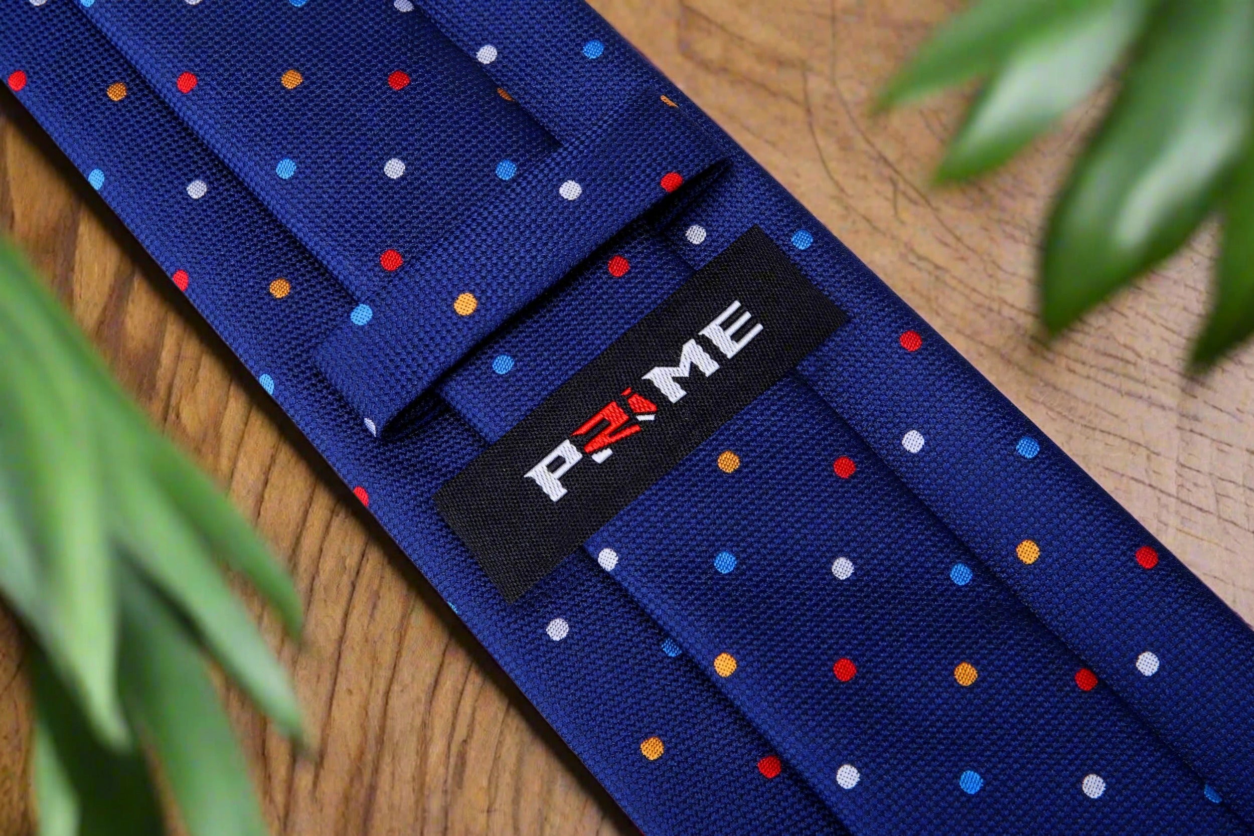 Green silk necktie displayed with a light blue dress shirt, highlighting its versatility.