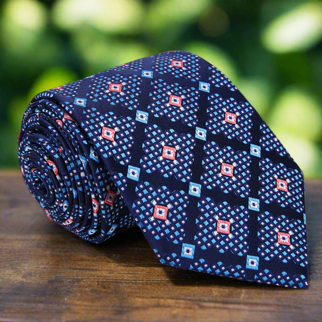 Close-up view of the vibrant purple and blue geometric necktie, showcasing its intricate patterns and colors.