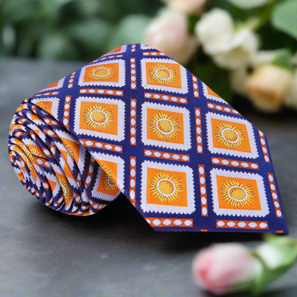 Close-up of vibrant geometric silk necktie with sunburst pattern in orange and blue