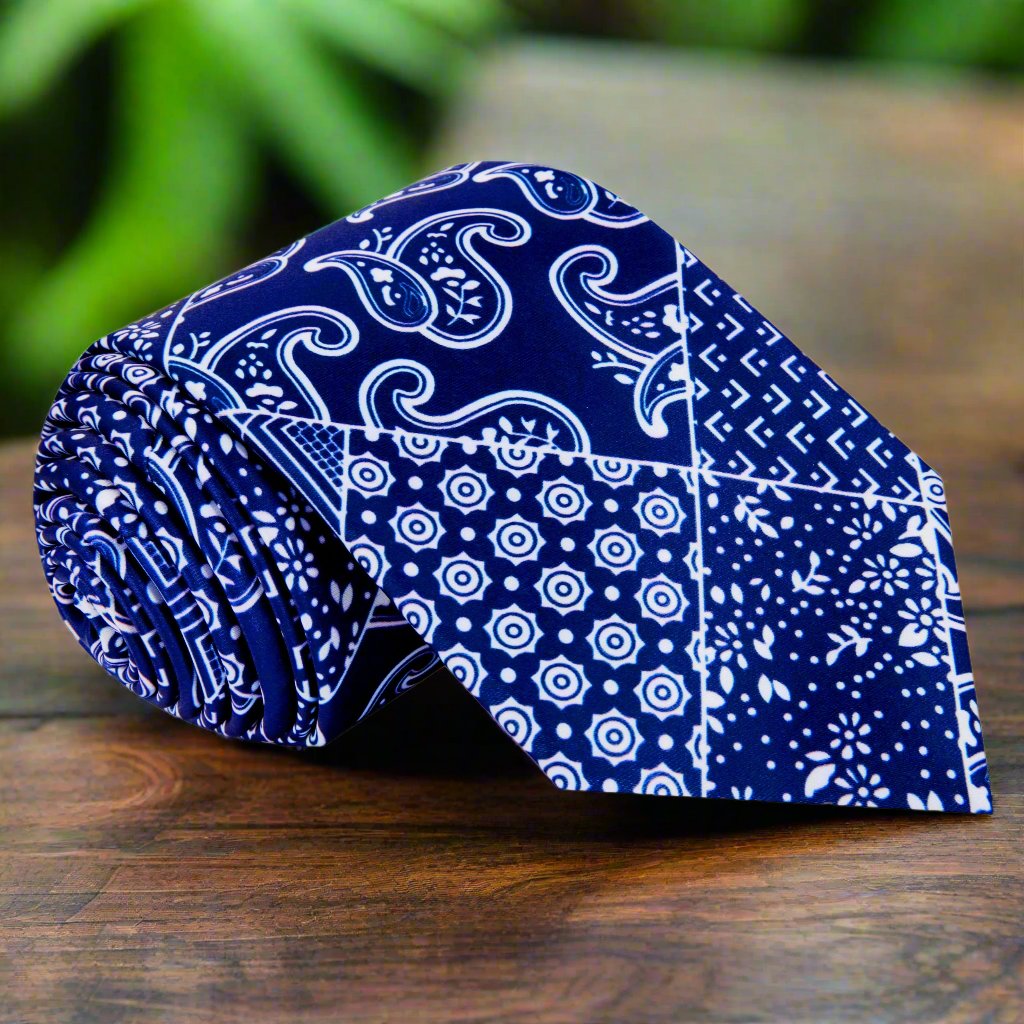 Midnight navy paisley necktie displayed on a white background, showcasing the intricate bandana pattern.